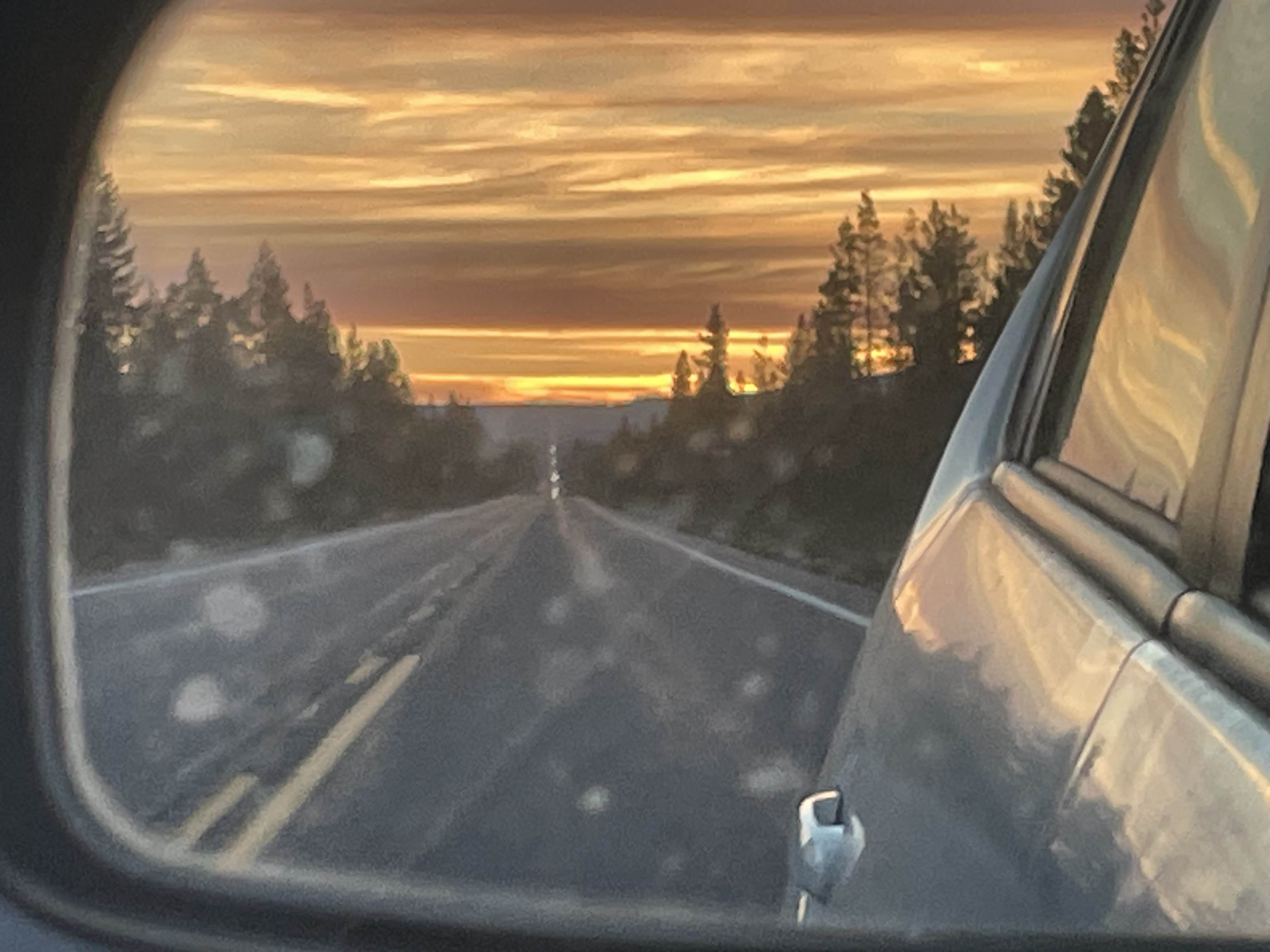 Rearview mirror with a flaming sunrise sky